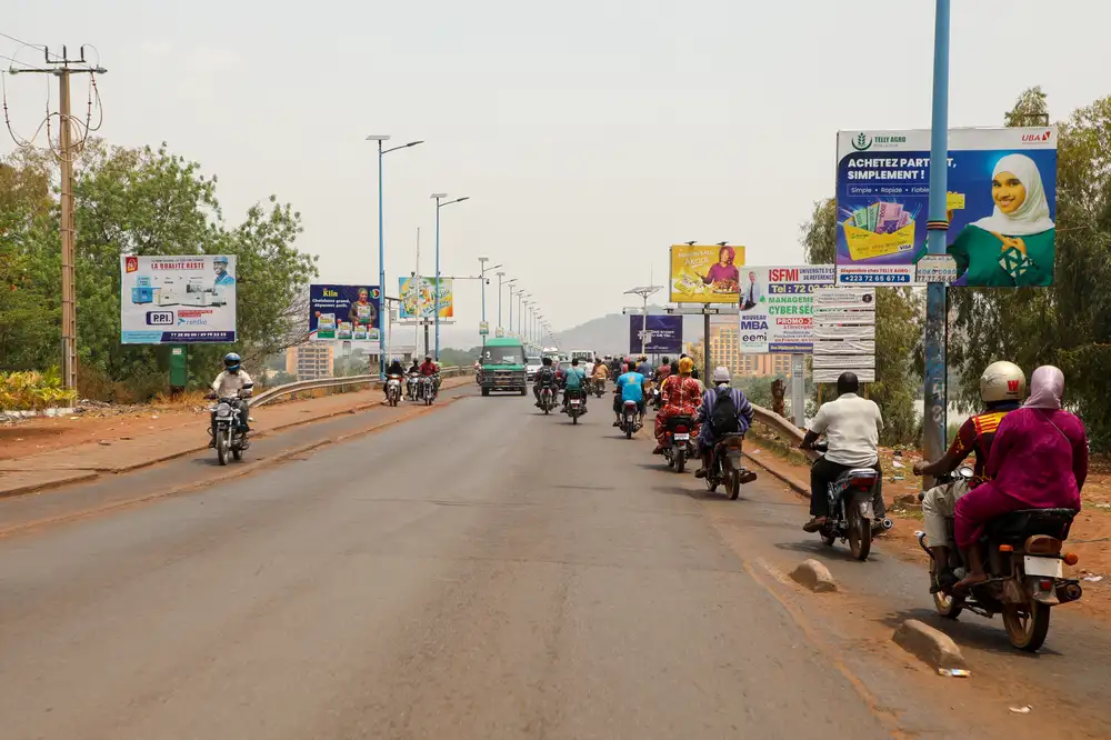 epa12917271 Commuters drive through the streets of Bamako, Mali, 27 April 2026. Malian authorities stated that a series of coordinated attacks were launched on 25 April by Islamic militants and separatists across the West African country. Following the assassination of Defense Minister Sadio Camara in a suicide car bombing at his Kati residence, the capital remains under a three-day overnight curfew.  EPA/HADAMA DIAKITE