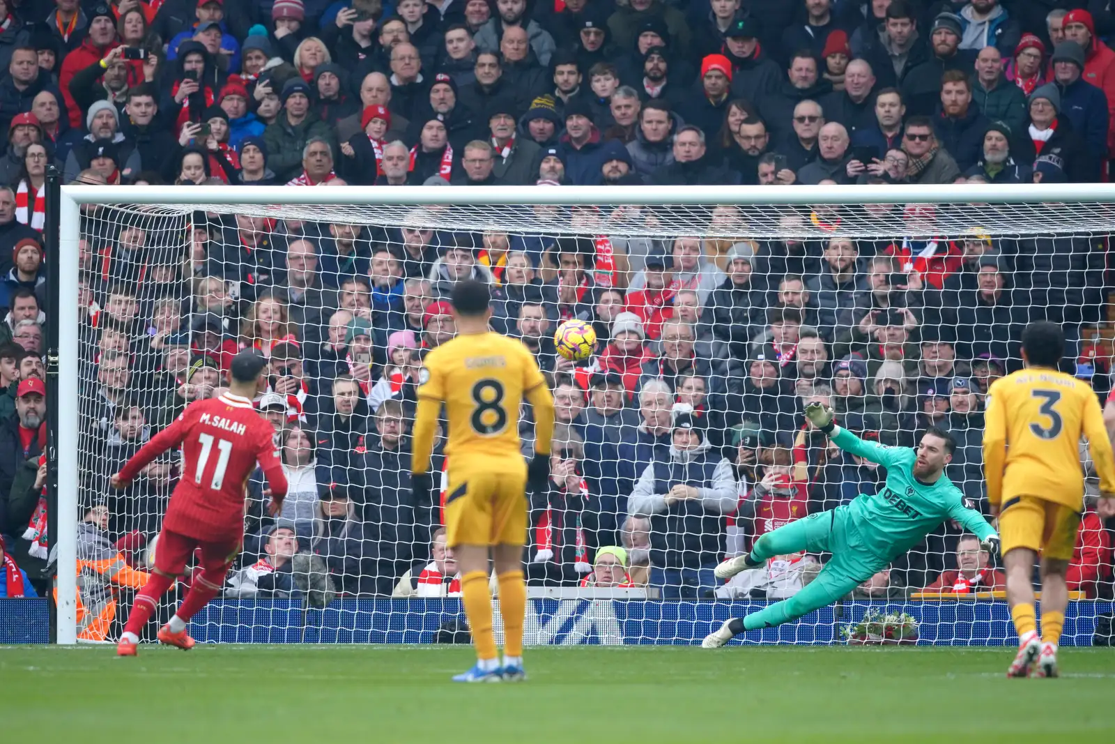 Liverpool's Mohamed Salah, left, shoots to score from the penalty spot during the English Premier League soccer match between Liverpool and Wolverhampton Wanderers at Anfield Stadium in Liverpool, Sunday, Feb. 16, 2025. (AP Photo/Ian Hodgson)