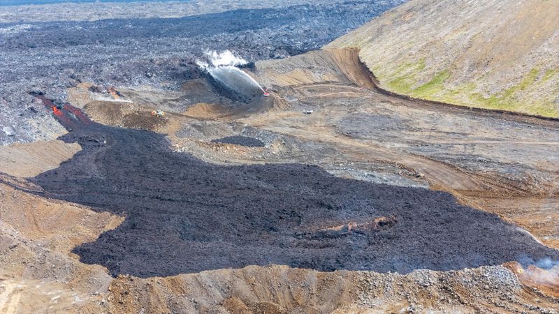 Varnargards at Sýlingarfell. Lava spills over gardens where water is sprayed for cooling.