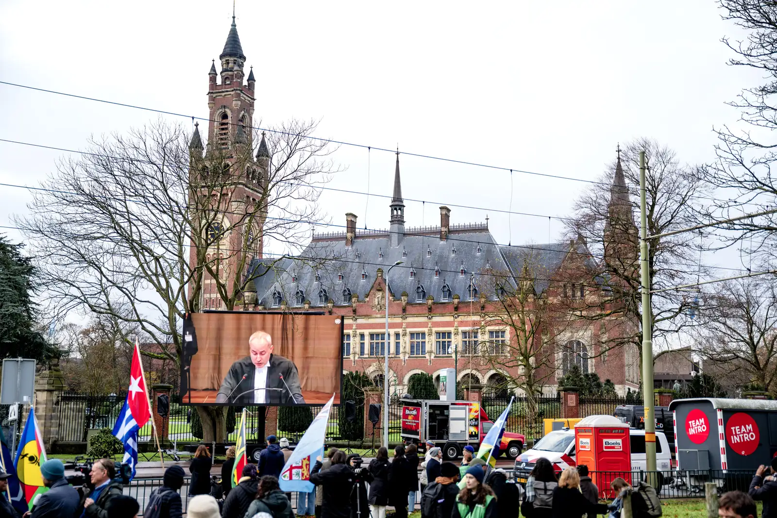 epa11752976 Climate activists watch a livestream while protesting outside the door of the International Court of Justice (ICJ) in The Hague, The Netherlands, 02 December 2024, where judges will spend from 02 until 13 December in a series of hearings examining countries' obligations in the fight against climate change. The case is taking place at the initiative of Vanuatu, a small Pacific island group east of Australia.  EPA-EFE/LINA SELG