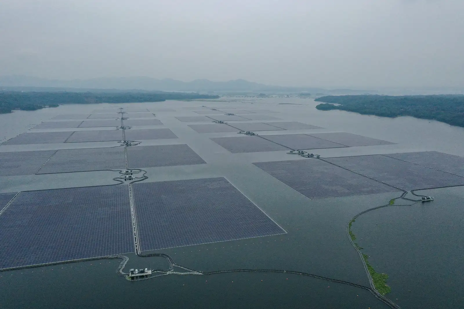 epa12043688 An aerial photo taken with a drone shows Cirata Solar Floating Photovoltaic (FPV) Power Plant operated by a joint venture between Indonesia's state-owned electricity company PLN Nusantara Renewables and the UAE's Masdar on the water of Cirata Reservoir in Purwakarta, West Java, Indonesia, 17 April 2025 (Issued on 21 April 2025). Officially inaugurated in 2023, the green power facility with 13 solar islands floating on a 200-hectare plot is the largest floating solar power facility in Southeast Asia, offsetting 214,000 tonnes of carbon dioxide emissions per year. Indonesia is expected to reach net zero emission in 2060. The theme for Earth Day 2025, celebrated on 22 April, is 'Our Power, Our Planet,' calling on people to embrace renewable energy.  EPA/MAST IRHAM