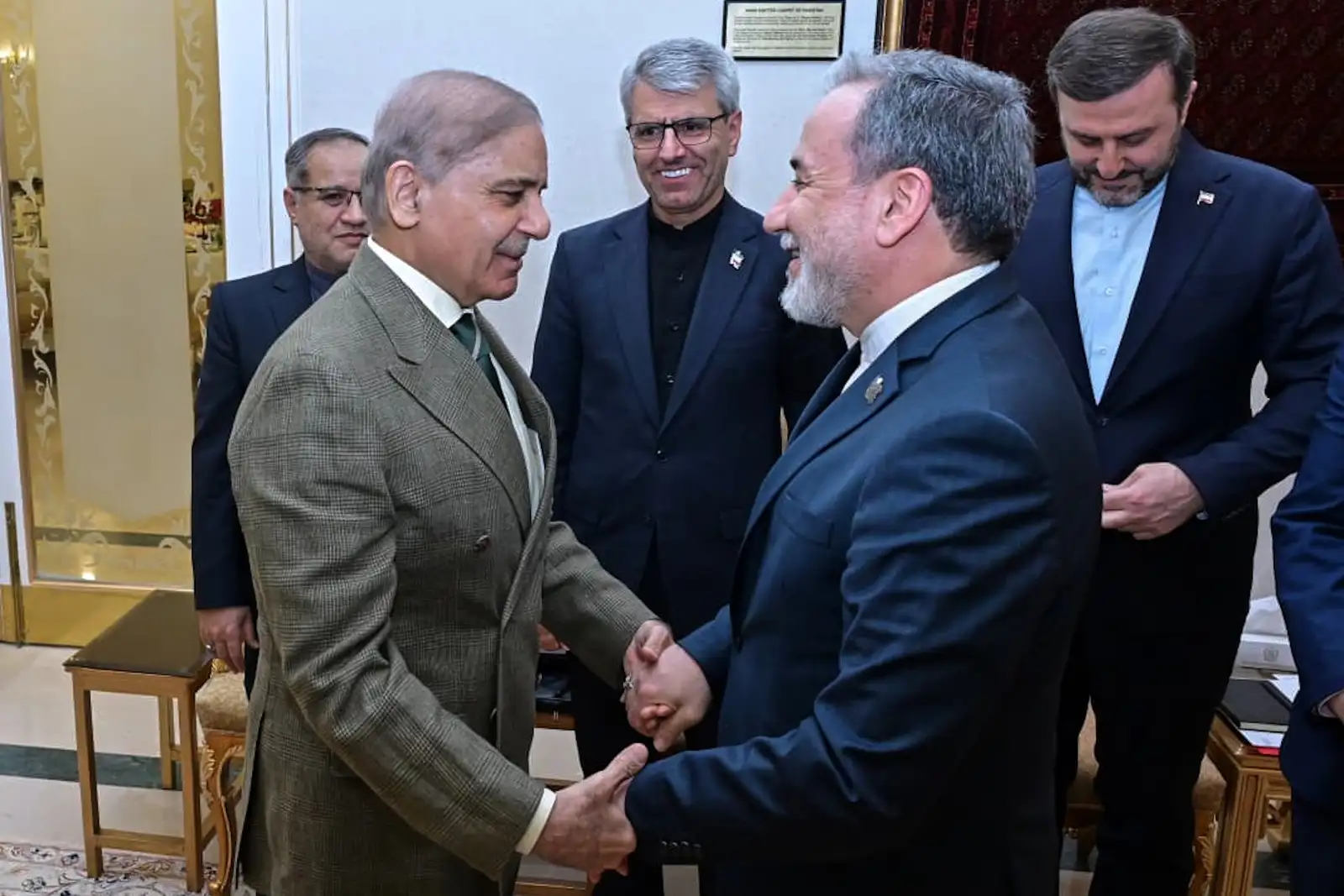 In this photo released by the Pakistan Prime Minister Office, Prime Minister Shehbaz Sharif, left, greets Iran's Foreign Minister Abbas Araghchi before their meeting in Islamabad, Pakistan, Saturday, April 25, 2026. (Pakistan Prime Minister Office via AP)