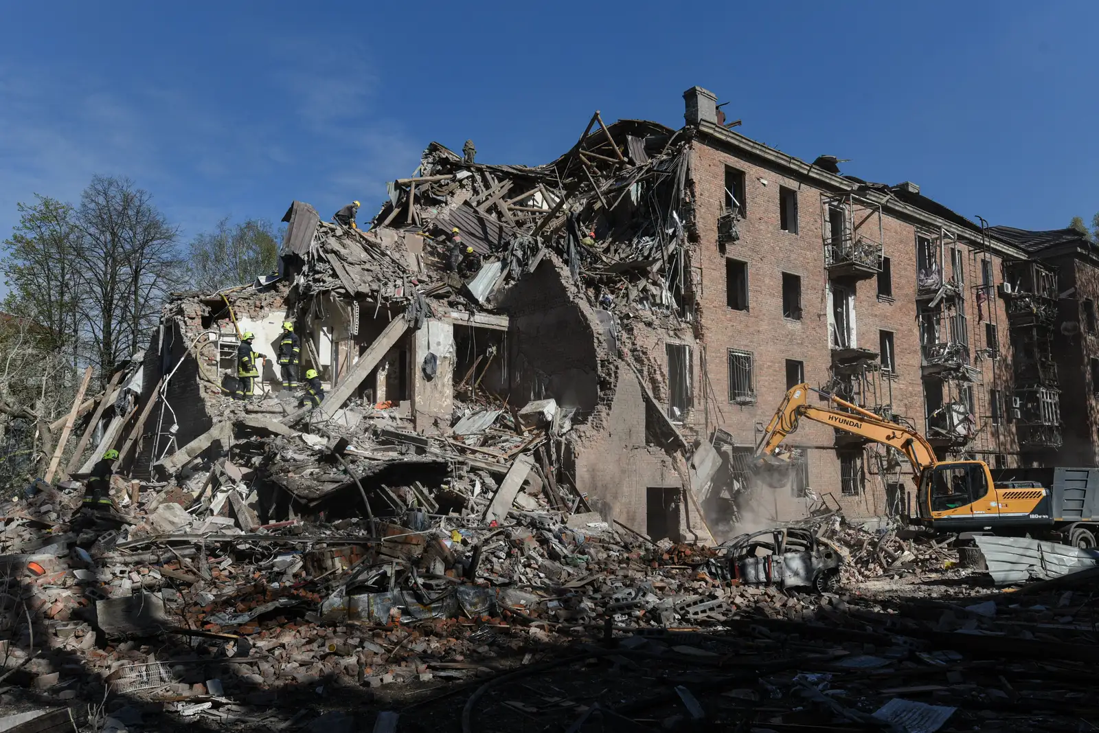 Rescue workers clear the rubble of a residential building destroyed by a Russian strike, in Dnipro, Ukraine, Saturday, April 25, 2026. (AP Photo/Mykola Synelnykov)