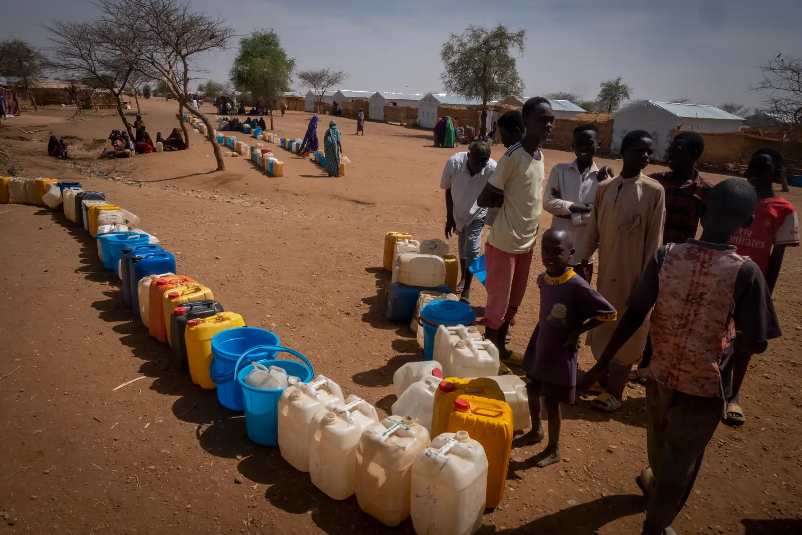epa11267332 Sudanese refugees wait for their turns to fetch water from wells made available by the NGO Doctors Without Borders (MSF) at the Farchana refugee camp near the East Chad Sudan border, 07 April 2024.(Issued 09 April 2024). Some 47.000 people live in the Farchana camp, each individual in this camp has access to less than 8 liters per person.  Lack or poor access to water is one of the many consequences of the humanitarian crises provoked the war in neighbouring Sudan which started on 15 April 2023. According to the UNHCR in March 2024, in one year more than 500,00 Sudanese refugees, mainly from Darfur region, have crossed into Chad looking for safety, 90 percent of them are women and children. As different humanitarian crises are unfolding in other parts of the world, both the UN and NGOs like MSF keep appealing for more aid to reach Sudan and avoid a looming famine situation in the already strained socio-economic context of Chad.  EPA/STRINGER