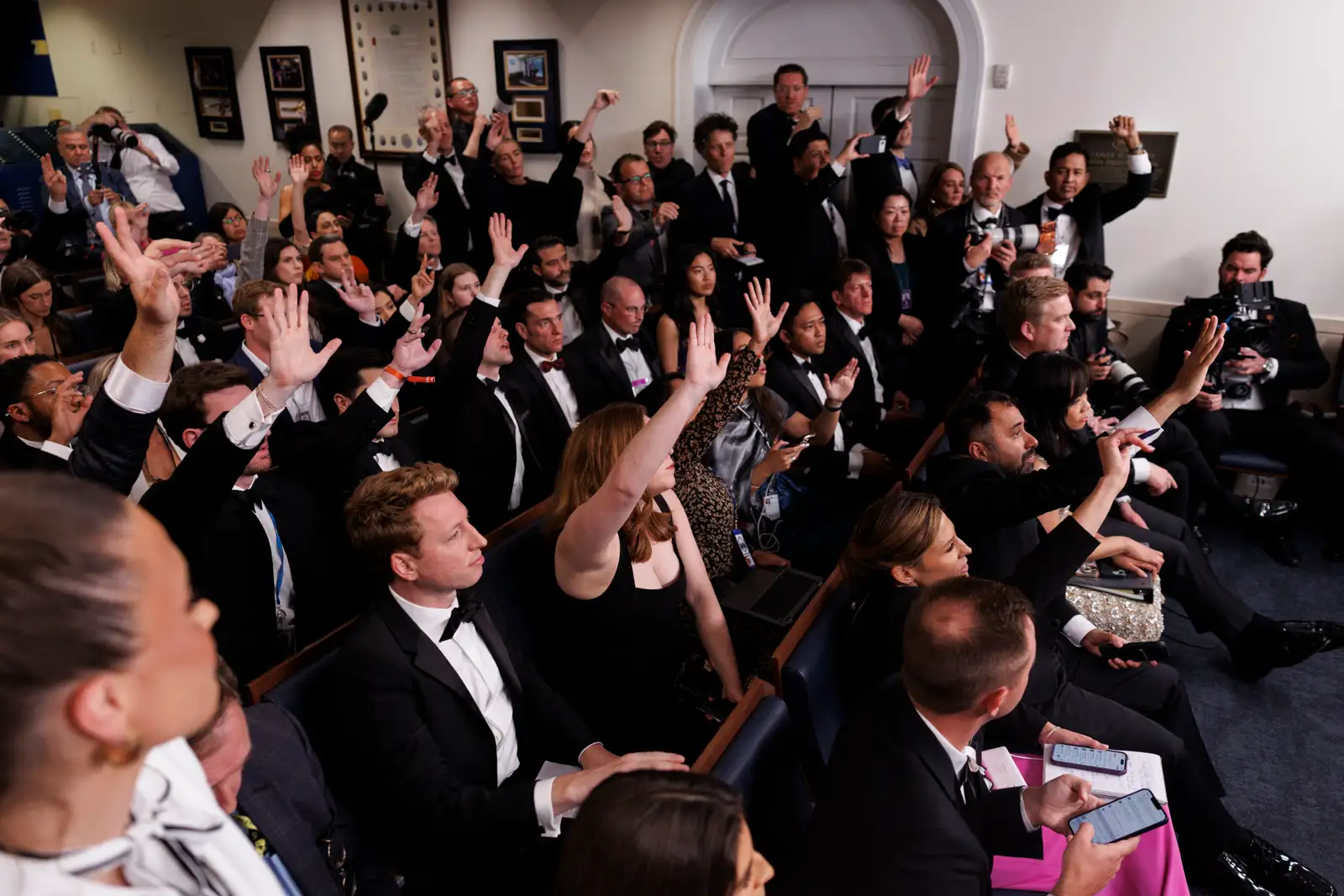 epa12914592 Reporters try to ask questions as US President Donald J. Trump speaks in the White House press briefing room after shots were fired outside the Washington Hilton ballroom hosting the White House Correspondents Association Dinner in Washington, DC, 25 April 2026. The alleged shooter is in custody.  EPA/WILL OLIVER