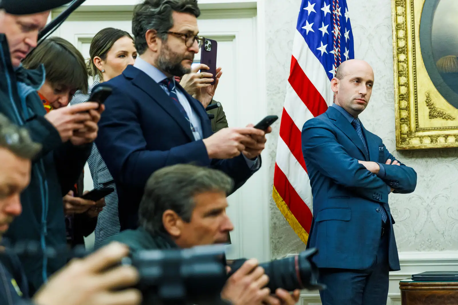 epa11889358 White House Deputy Chief of Staff Stephen Miller (R) looks on in the Oval Office as US President Donald Trump meets with Elon Musk (not pictured) in the White House in Washington, DC, USA, 11 February 2025.  EPA-EFE/Aaron Schwartz / POOL