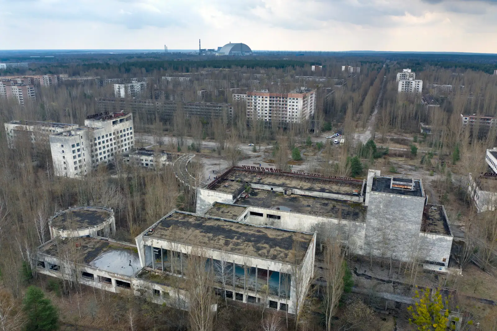 FILE - A dome-shaped shelter covering the damaged reactor at the Chernobyl nuclear plant is seen on the horizon, April 15, 2021, from the abandoned town of Pripyat, Ukraine, once home to some 50,000 people whose lives were connected to the plant. (AP Photo/Efrem Lukatsky, File)