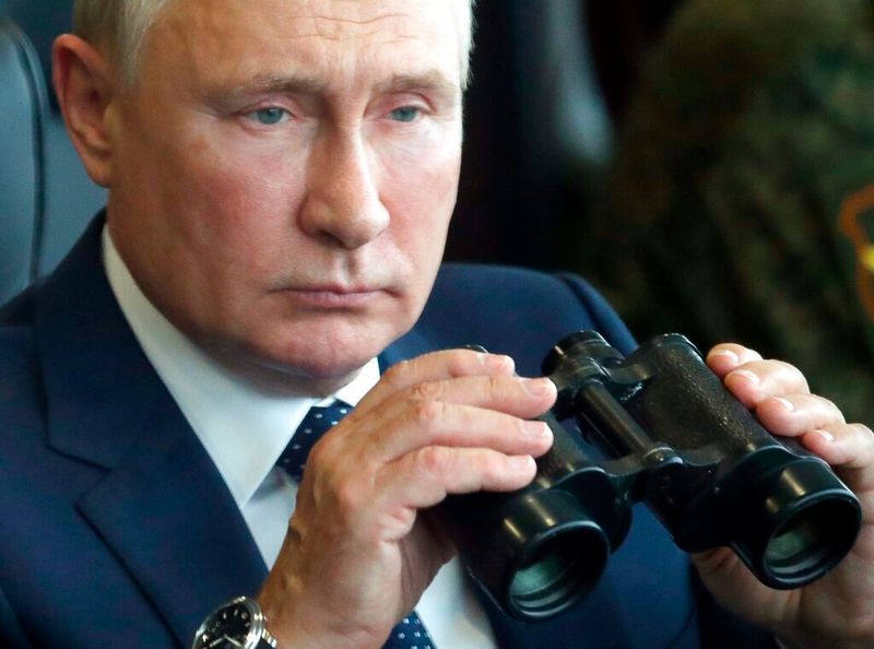 FILE - Russian President Vladimir Putin holds a binoculars as he watches the joint strategic exercise of the armed forces of the Russian Federation and the Republic of Belarus Zapad-2021 at the Mulino training ground in the Nizhny Novgorod region, Russia, on Sept. 13, 2021. The Kremlin has rejected Ukrainian and Western allegations that it amassed troops preparing for possible invasion of Ukraine, describing the claims as a cover for their own alleged aggressive designs. (Sergei Savostyanov, Sputnik, Kremlin Pool Photo via AP, File)