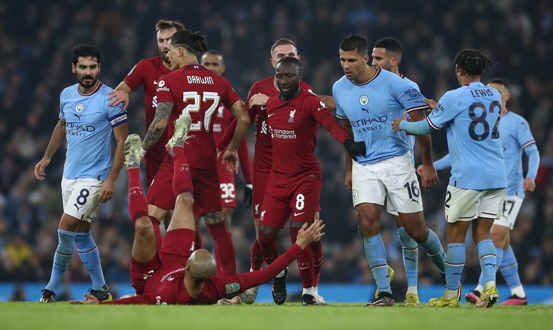 Fabinho of Liverpool (down) falls on his back as a result of a scuffle between the players of both teams during the Carabao Cup Round of 16 soccer match between Manchester City and Liverpool FC in Manchester, Britain, 22 December 2022.