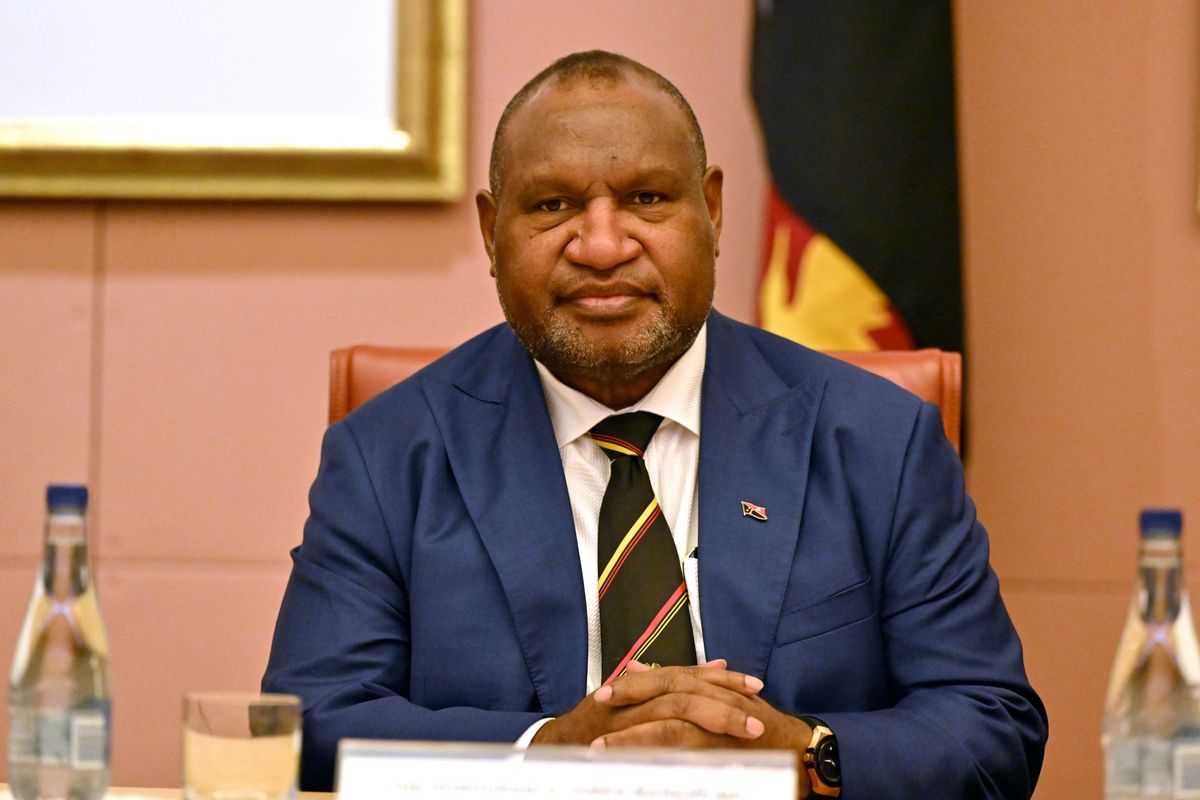 Papua New Guinea Prime Minister James Marape wearing a blue suit, light shirt with a striped tie, as he holds a meeting with Australian Prime Minister Anthony Albanese on December 7, 2023.