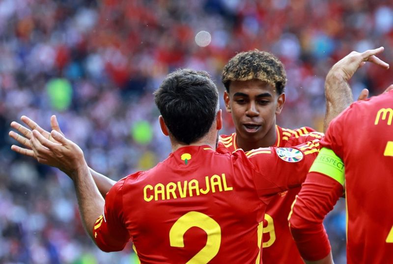 Dani Carvajal of Spain (front) celebrates scoring the 3-0 with Lamine Yamal of Spain during the UEFA EURO 2024 group B match between Spain and Croatia in Berlin, Germany, 15 June 2024.